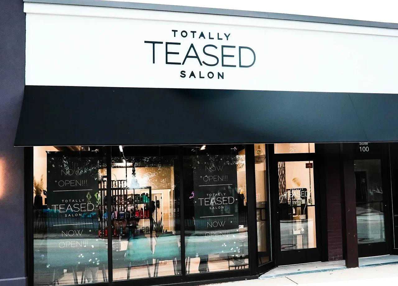 Storefront of Totally Teased Salon with visible interior and products.